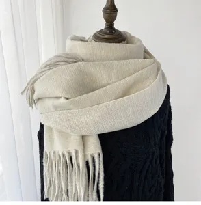 Solid color soft warm winter tassel scarf close-up detail, elegant daily wear accessory.