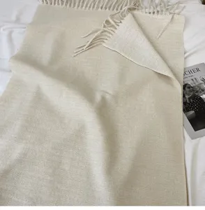 Beige solid color tassel cashmere feel scarf detail view, elegant winter cozy shawl drape.