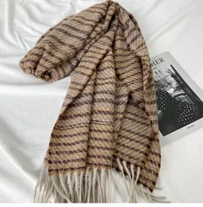 Detailed view of the autumn winter brown striped cashmere feel fringe scarf prop display.
