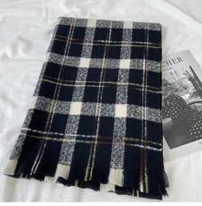 Classic black and white plaid winter scarf with fringe detail, cozy long shawl design.
