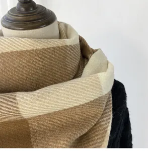 Cozy winter plaid scarf in warm beige and brown tones, soft woolen texture for women.