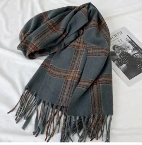 Detailed close-up view of grey brown plaid tassel scarf for cozy winter daily wear.