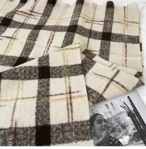 Detailed view of winter thick plaid scarf, classic retro pattern, soft and warm shawl accessory.