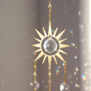 Crystal suncatcher detail, hanging golden sun pendant with sparkling crystal ball.