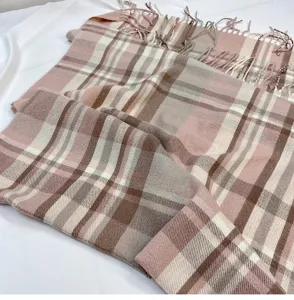 Detailed view of women's autumn winter pink plaid imitation cashmere scarf with soft tassels.