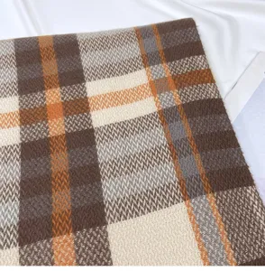 Close-up detail of women's winter cashmere-feel plaid scarf, soft knitted texture pattern.