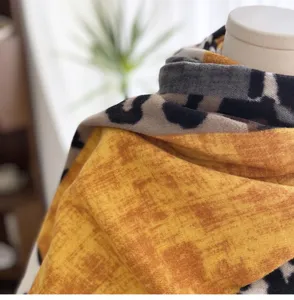 Close-up detail of women's autumn winter colorblock leopard print imitation cashmere scarf.