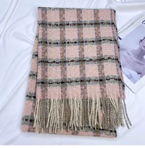 Detail view of the pink plaid cashmere-feel winter scarf with elegant fringe and grid pattern.