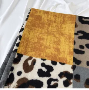 Close-up detail of color-block leopard print cashmere-feel winter scarf with soft tassels.
