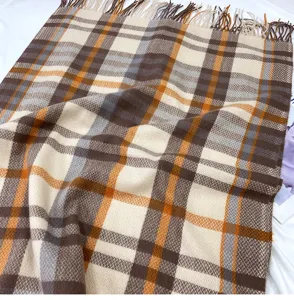 Cozy winter plaid tassel scarf for women, classic brown and orange check shawl wrap for cold weather.