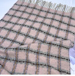 Detail shot of autumn winter pink plaid tassel scarf, soft warm material shawl wrap woman.