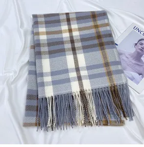 Detail shot of women winter blue plaid cashmere feel scarf with chic tassel hem.