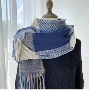 Detailed view of the cozy blue and beige grid tassel scarf, showcasing soft cashmere-like texture.