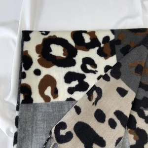 Cozy leopard print cashmere-feel scarf with chic color block design and stylish fringe.