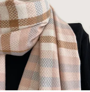 Classic pink plaid winter scarf detail shot, showing soft imitation cashmere fabric texture clearly.