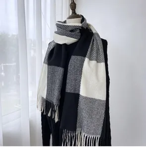 Close-up of the black white grey checkered scarf showing soft imitation cashmere and tassel trim.