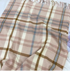 Detailed shot of winter warm plaid cashmere-feel tassel scarf with classic tartan pattern.