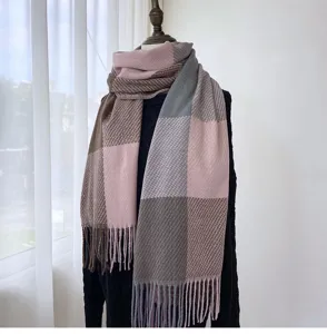 Detailed view of the cozy color-block plaid scarf with soft texture and elegant fringe hem.