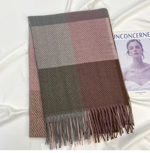 Detailed shot of winter color-blocked plaid scarf with soft fringe and warm feel.