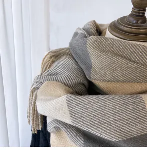 Detailed shot of cozy winter plaid tassel scarf, soft cashmere-feel fabric texture.