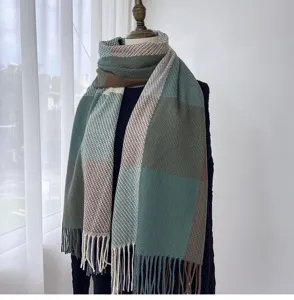 Detail view of the green and brown plaid scarf featuring soft fabric and classic fringe tassels.