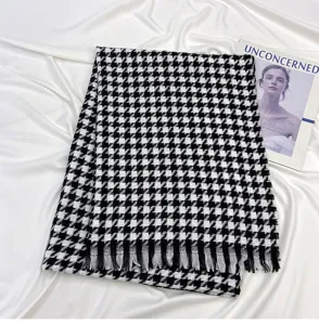 Classic black and white houndstooth scarf with elegant fringe for winter warmth and daily style.