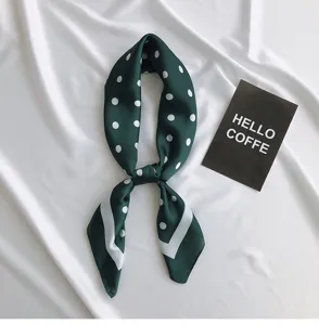 Dark green polka dot silk scarf detail, elegant square neckerchief for stylish daily outfit.