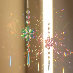 Crystal suncatcher detail showing snowflake pendant refracting gorgeous rainbow light effects.