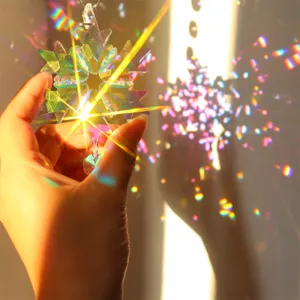 Detailed close-up of a sparkling crystal snowflake suncatcher reflecting vibrant rainbow light.