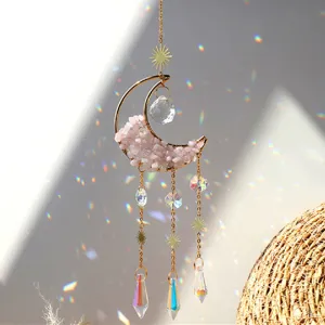 Crystal suncatcher with pink quartz moon and prisms casting rainbows for window home decor.
