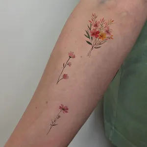 Watercolor floral temporary tattoo stickers, vibrant bouquet design for arm and body art decoration.