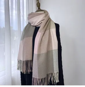 Cozy imitation cashmere plaid scarf detail showcasing soft pastel color blocks and fringe.