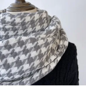 Detail view of winter warm houndstooth scarf texture cozy fabric style fashion accessory