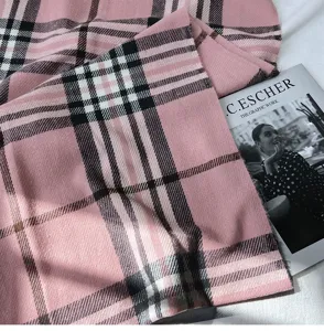 Detail shot of women's pink imitation cashmere plaid scarf, soft texture and classic British check.