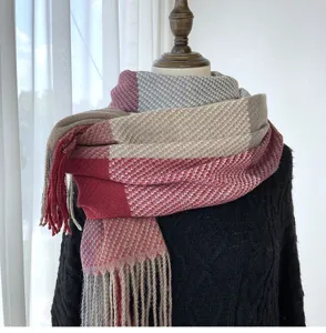 Detailed view of the cozy winter plaid cashmere-feel scarf with fringe, elegant texture.