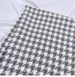 Close up view of the grey and white houndstooth scarf texture, soft cashmere feel fabric detail.