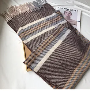 Cozy cashmere-feel plaid winter scarf featuring soft fringe trim, warm detailed fabric close-up.