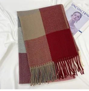 Detailed view of a cozy winter color-blocked plaid scarf featuring stylish tassel hem.