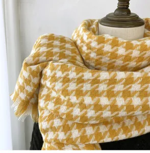 Close-up of yellow white houndstooth winter scarf detail, soft imitation cashmere warm tassel.