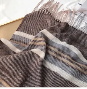 Close-up of cozy imitation cashmere striped scarf with fringe for women winter warmth style.