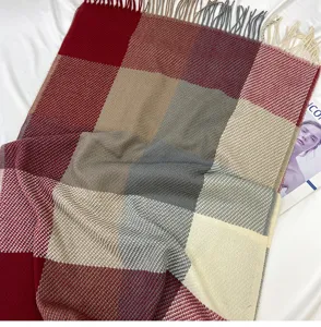 Detailed close-up view of autumn winter plaid cashmere feel scarf with fringe tassel design.