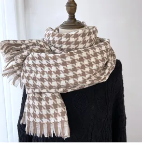 Brown white houndstooth pattern detail of winter warm tassel scarf texture close up