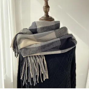 Close-up of a classic plaid winter scarf with fringe detail, showcasing texture and pattern.
