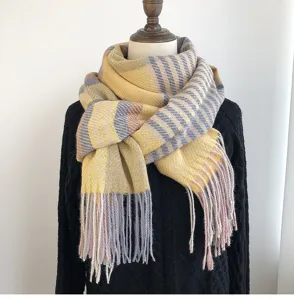 Detailed view of a cozy yellow grey and pink striped winter tassel scarf for women and girls.