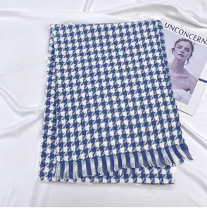 Blue and white houndstooth pattern scarf detail, featuring soft fabric and delicate fringe hem.