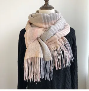 Close-up detail of women winter cashmere-like plaid fringe scarf, warm and soft texture.