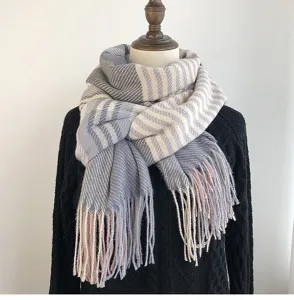 Detailed view of the cozy winter tassel scarf with soft cashmere-like texture and stripes.