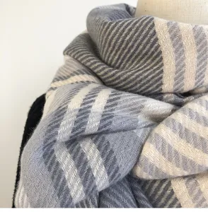 Winter warm scarf in grey and beige herringbone plaid, cozy thick knit fabric detail view.