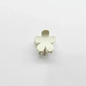 Close-up detail shot of a cute matte flower hair claw clip, perfect for styling tiny sections.