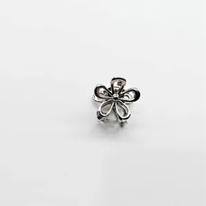 Silver alloy mini flower hair claw clip for women, cute small hair accessory and styling tool.